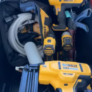 DeWalt 20V cordless tool assortment with tote. Includes an 18-gauge brad nailer, caulking gun, (2) drills/drivers, batteries, tool bag, and QuicStick 