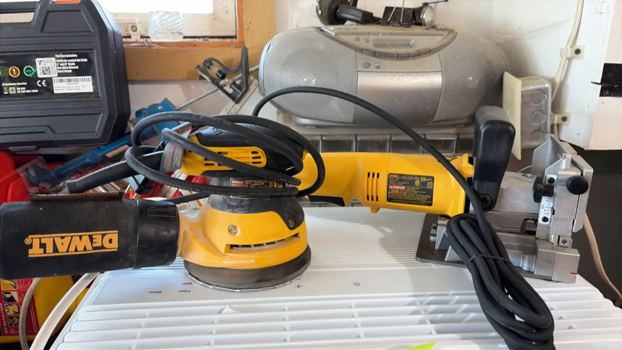 DeWalt woodworking power tool lot. Includes a DeWalt DWE6421 random orbit palm sander with attached dust bag and a DeWalt DW682 plate joiner. Electric