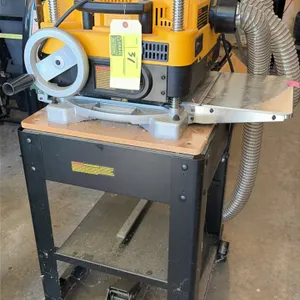 2022 DeWalt DW735 13" thickness planer. Features a two-speed gearbox, infeed and outfeed extension tables, and a dust port with flexible hose. S/N: 20