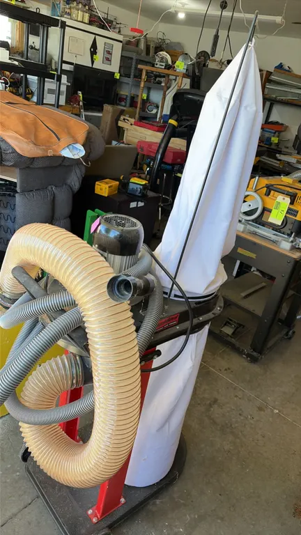Bucktool DC50 mobile dust collector. Features 1.2 HP motor, 750 CFM air flow, 3450 RPM, and 4" hose diameter. Includes upper filter bag, lower collect