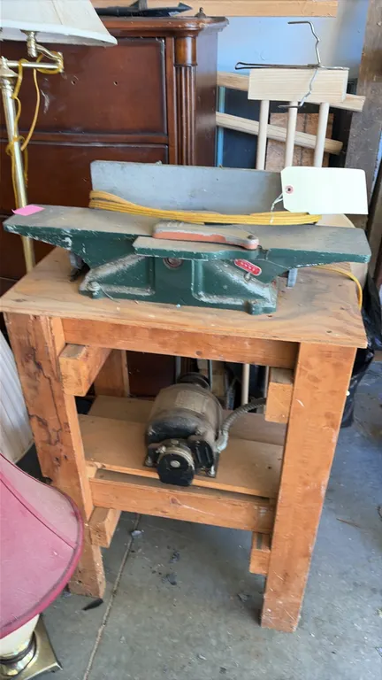 Shopmaster 6" jointer. Features cast iron construction, adjustable fence, and spring-loaded blade guard. Includes electric motor and drive belt. Mount