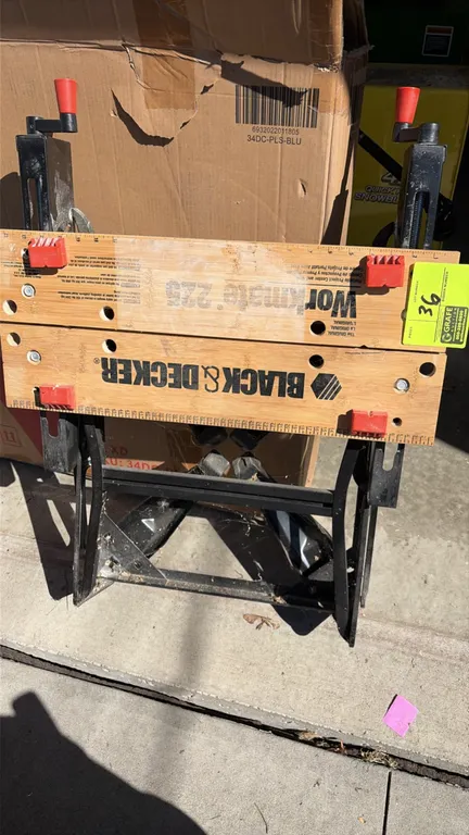 Black & Decker Workmate 225 portable project center and vise table. Features dual clamping cranks, wooden vise jaws with printed measurement markings,