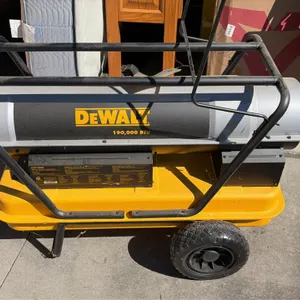DeWalt DXH190HD forced air torpedo heater. Features 190,000 BTU heat output, adjustable thermostat control, integrated fuel tank, and tubular roll cag