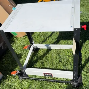JET portable metal work table. Features adjustable-height legs and side adjustment knob. Mounted on a mobile base with casters and foot locks. Dimensi