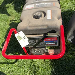 Troy-Bilt portable gas generator. Powered by a Briggs & Stratton engine. Features 5,500 running watts, 8,250 starting watts, four 120V 20A outlets, an