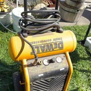 DeWalt Emglo portable air compressor. Features 4.5-gallon tank, 200 PSI max pressure, 1.8 HP motor, and 5.2 SCFM at 90 PSI. Equipped with dual pressur
