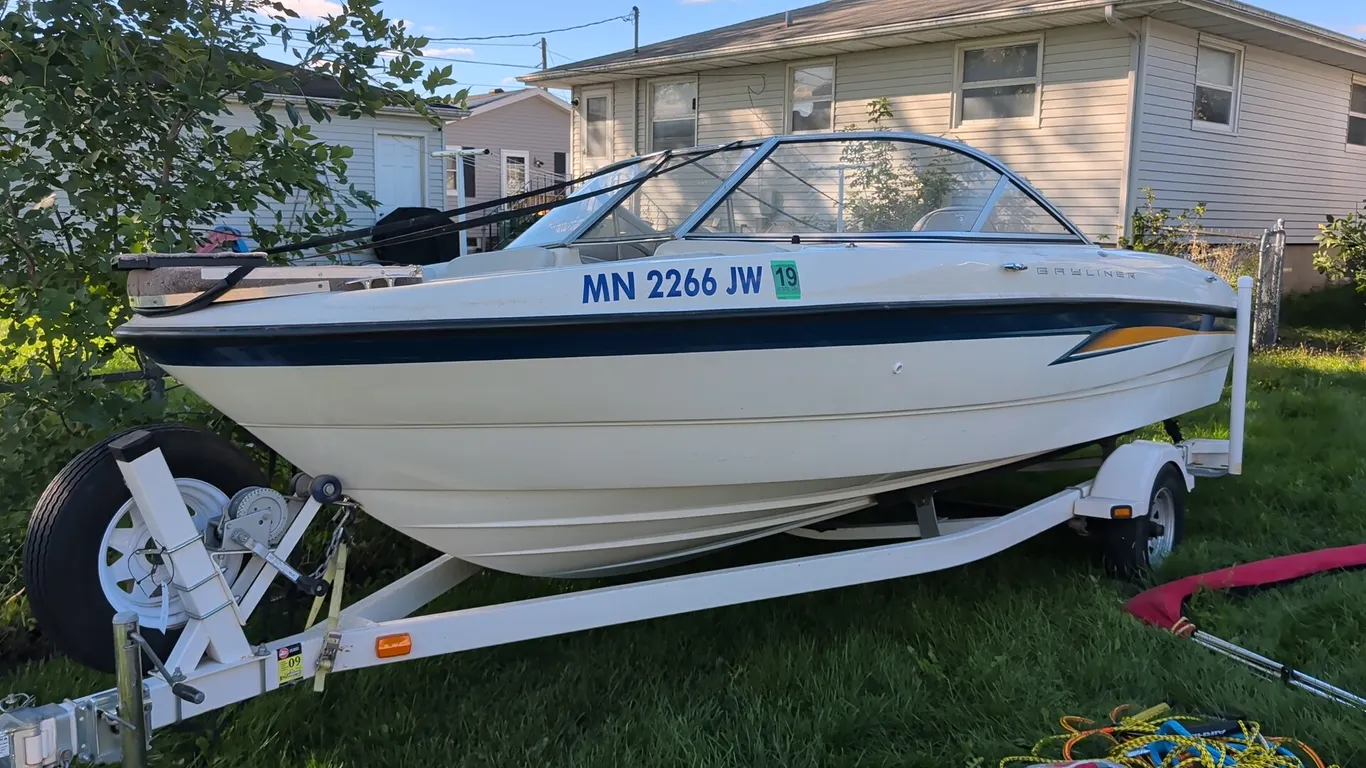 2004 Bayliner 185 17' runabout boat with Karavan single-axle trailer. Powered by a Mercury MerCruiser 3.0L inboard/outboard engine. Features walkthrou