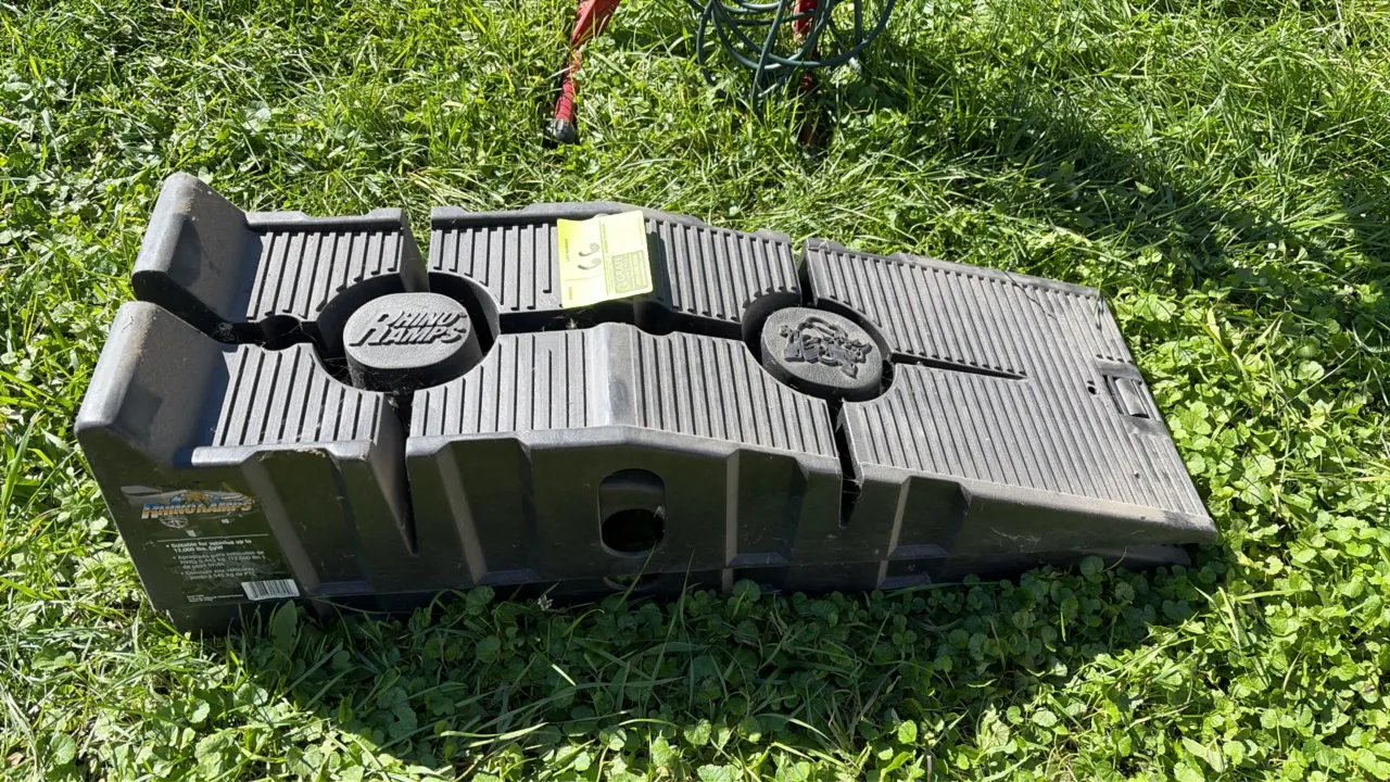 RhinoRamps polymer automotive service ramps. Includes a pair of black molded plastic ramps featuring a textured tread surface and nesting design. Labe