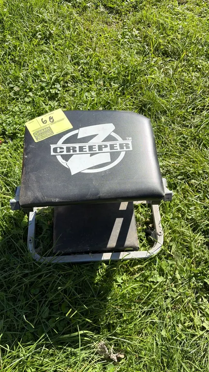 Z Creeper folding mechanic seat. Features a black vinyl padded cushion, convertible folding metal frame, and swivel casters. Note: Scale shown not inc