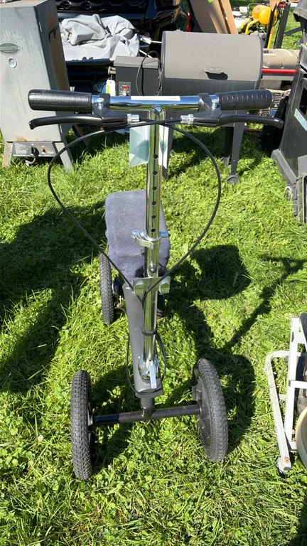 All-terrain steerable knee scooter. Features dual hand brake levers, adjustable-height handlebar and knee platform, padded knee cushion with fabric co
