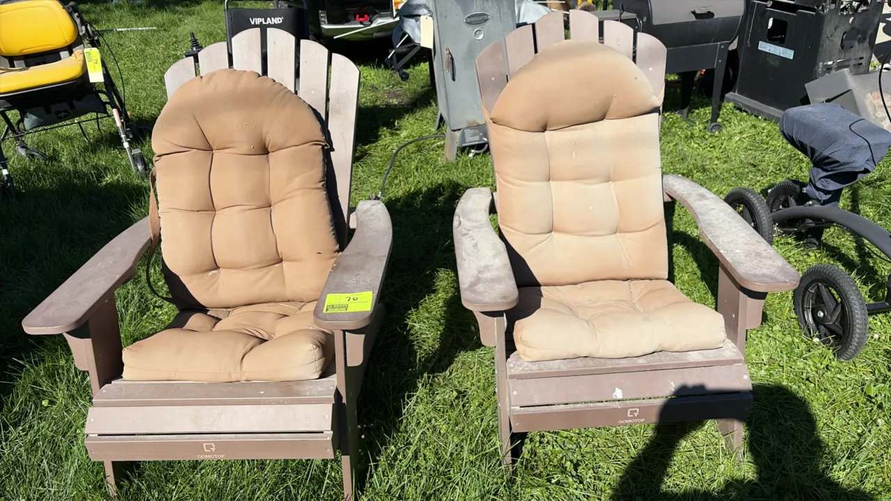 GOMOTOP poly Adirondack chairs. Includes (2) chairs featuring brown poly lumber slatted construction, wide armrests, and padded tan seat cushions.