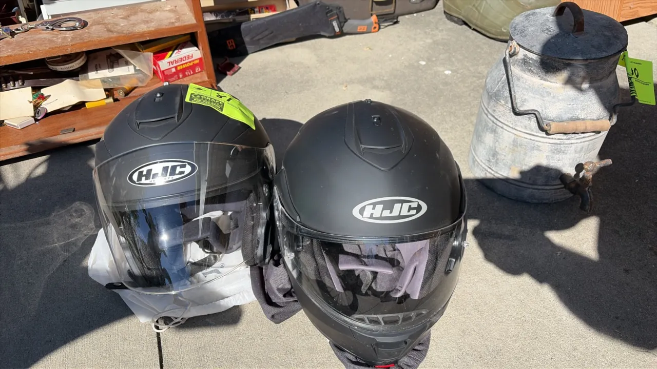 HJC XXL motorcycle helmets. Features matte black finish, integrated top vents, padded interior lining, and clear face shields.