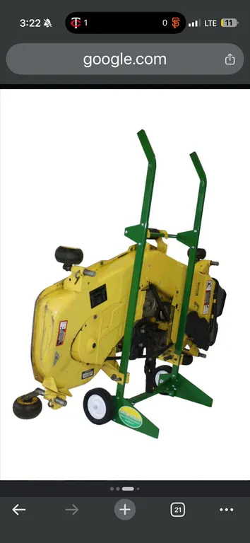 Deck Dolly mower deck storage dolly. Features steel frame construction with green finish, dual transport wheels, and upright support brackets for vert