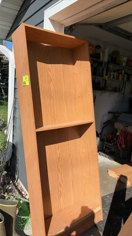 Wood laminate bookshelf. Features an oak-look finish, recessed kickplate base, and pre-drilled pin holes for adjustable shelving. 3'W.