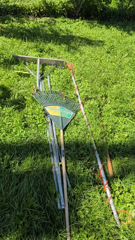 Outdoor maintenance tool lot. Includes an aluminum roof snow rake with sectional pole extensions, a manual pole tree pruner with saw blade and pull co