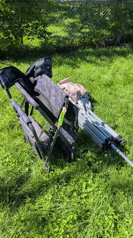 Pop-up canopy and folding camp chair. Includes collapsible canopy frame with fabric cover and a folding camp chair featuring camouflage patterned fabr