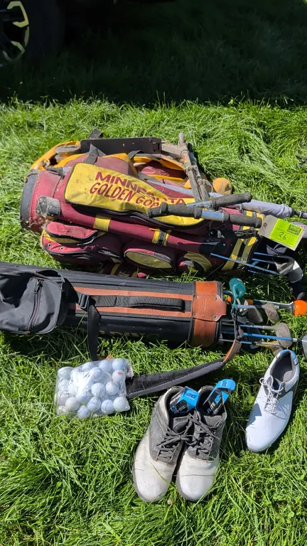 Sporting goods and golf equipment lot. Includes (2) golf bags with assorted clubs (featuring a Minnesota Golden Gophers bag and a Spalding bag), (2) p