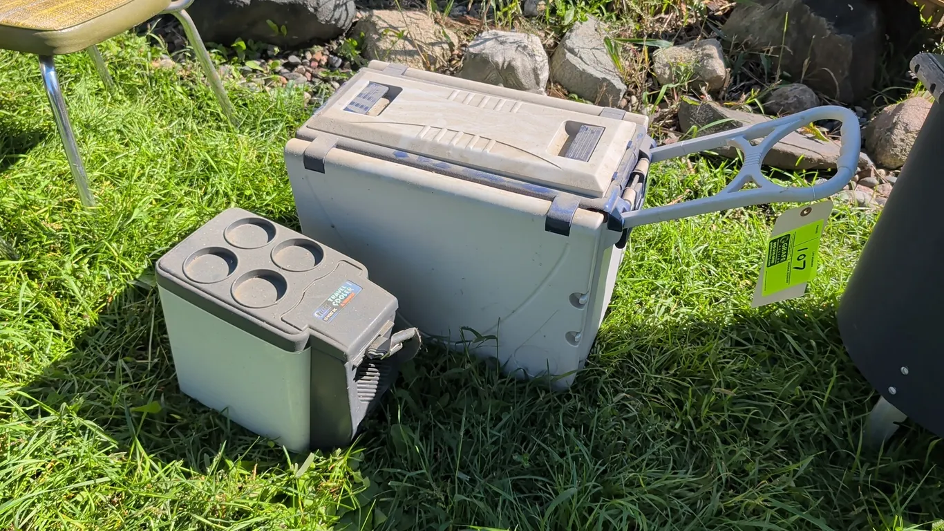 Portable cooler package. Includes Vector 12V DC travel cooler and warmer featuring four integrated lid cup holders and carry strap, alongside a rollin