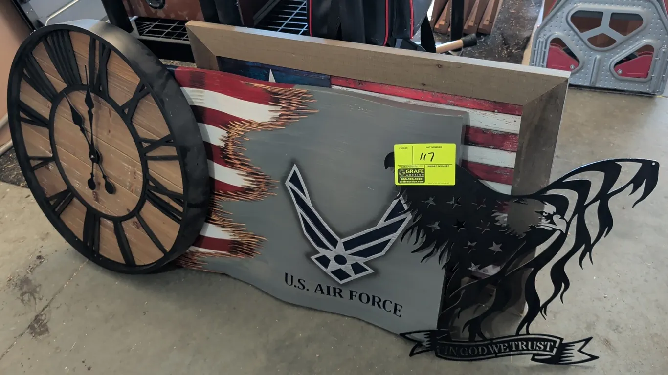 Patriotic decorative wall art selection. Includes a round wall clock with Roman numerals and wood plank face, a wavy carved wooden U.S. Air Force Amer