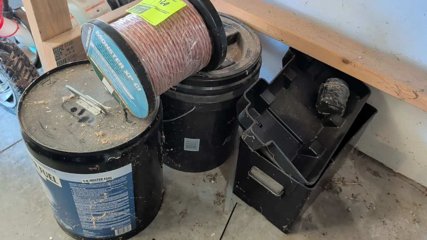 Assorted utility and garage supplies. Includes a spool of Monster Cable Monster XP-CI CL3-rated speaker cable, Klean-Strip 1-K heater fuel kerosene ca