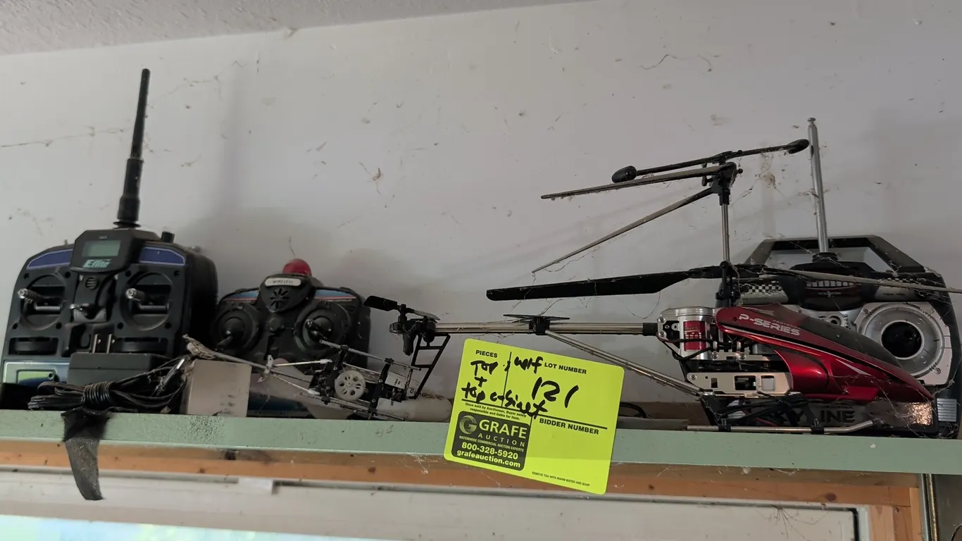 Assorted shelf and cabinet top contents including remote-controlled helicopters and accessories. Features Protocol Skyline RC helicopter, E-flite Blad