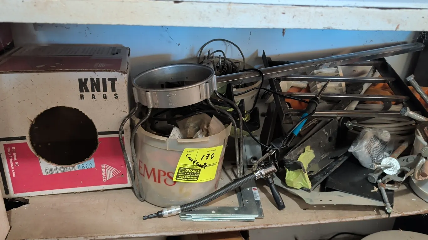 Assorted workshop contents and hardware. Includes buckets of miscellaneous fasteners, C-clamps, mounting brackets, metal frame pieces, flexible extens