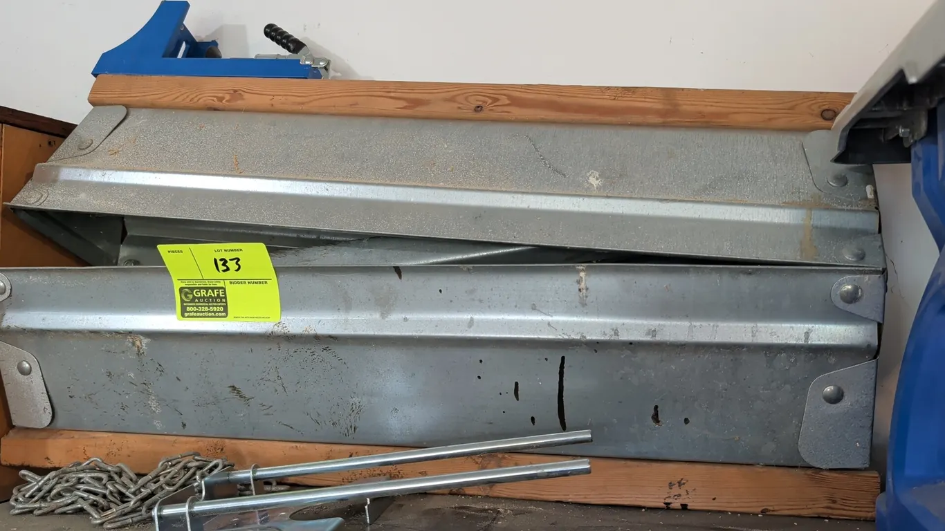 Pair of metal folding sawhorses. Features galvanized steel construction, folding legs, and wood top rails. 32"L.