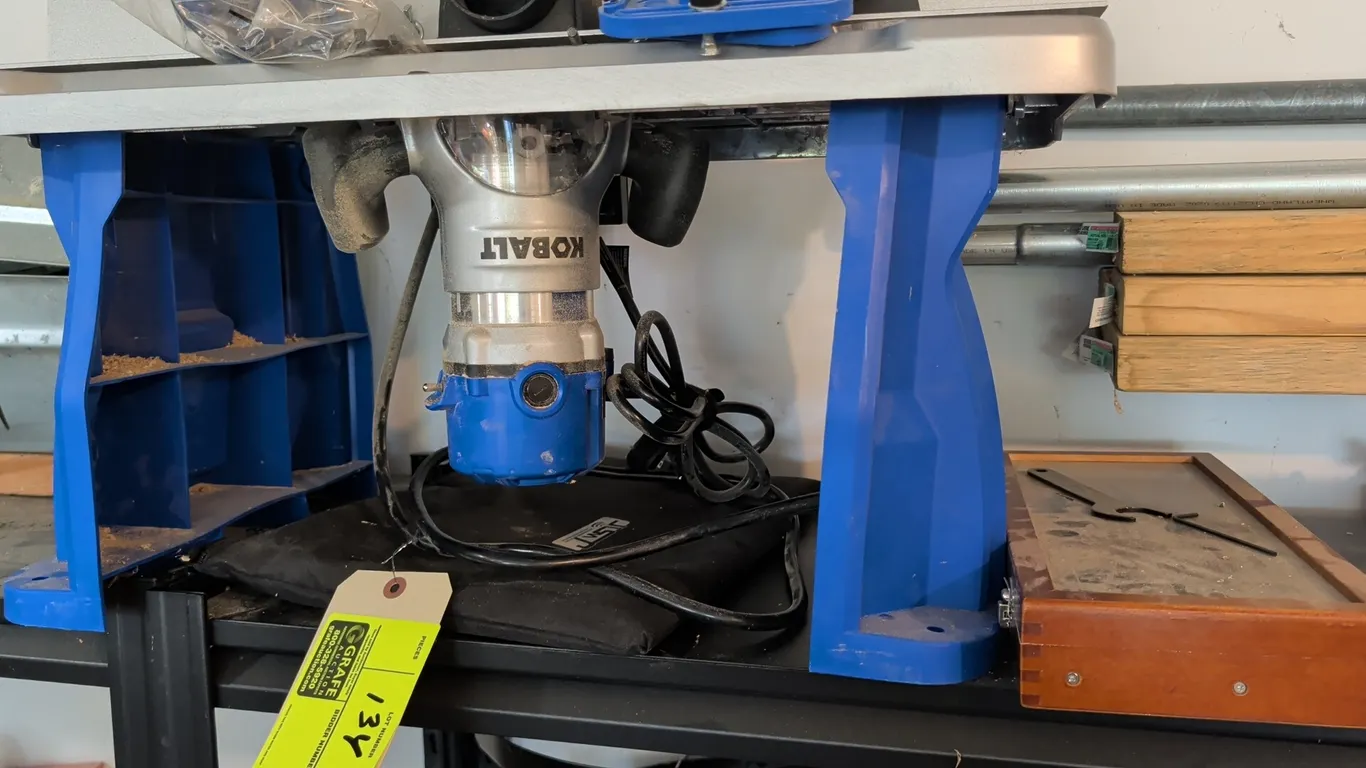 Kobalt router with router table and bit set. Features benchtop table with aluminum top, adjustable fence, featherboards, and dust port. Includes a woo