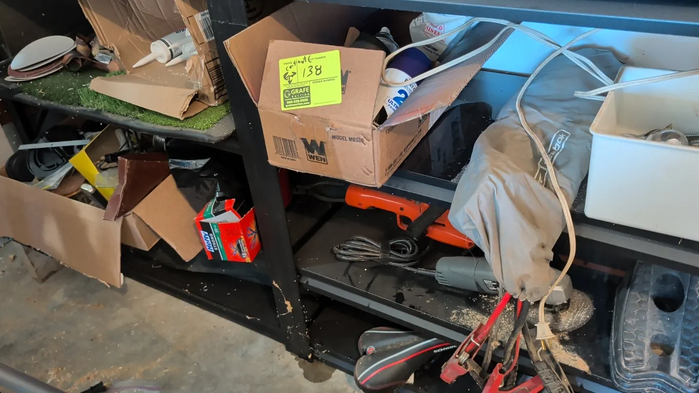 Assorted tools, shop supplies, and hardware. Includes electric handheld angle grinder, corded electric hedge trimmer, automotive jumper cables, contai