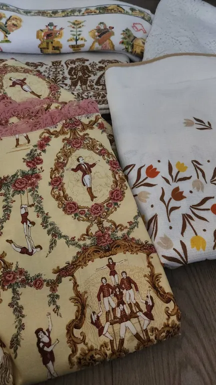 Decorative Table Linens Including Lace Tablecloth and Printed Fabric Runners
