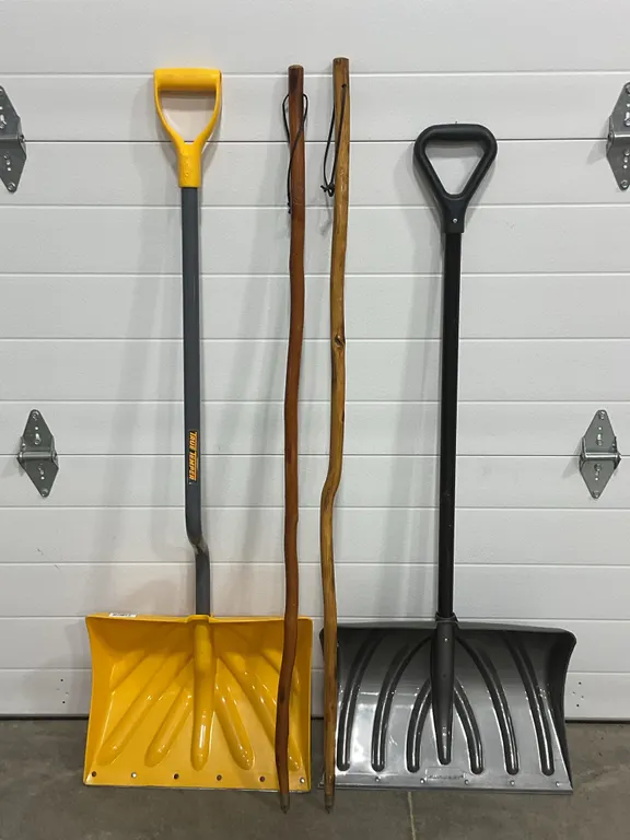 Assorted Snow Shovels and Wooden Walking Sticks