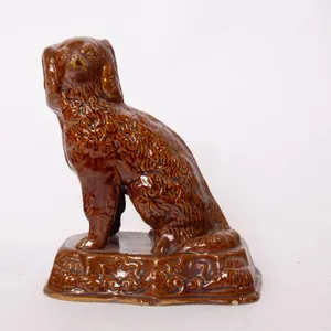 ROCKINGHAM SPANIEL FIGURE IN BROWN GLAZE.