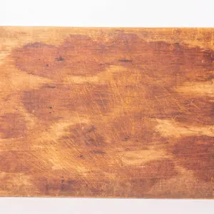 PRIMITIVE WOODEN BOARD WITH A WARM AGED PATINA.