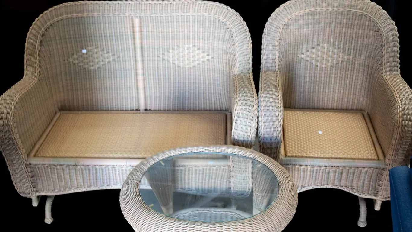WICKER DOUBLE ROCKER, SINGLE ROCKER, AND OVAL GLASS TABLE.