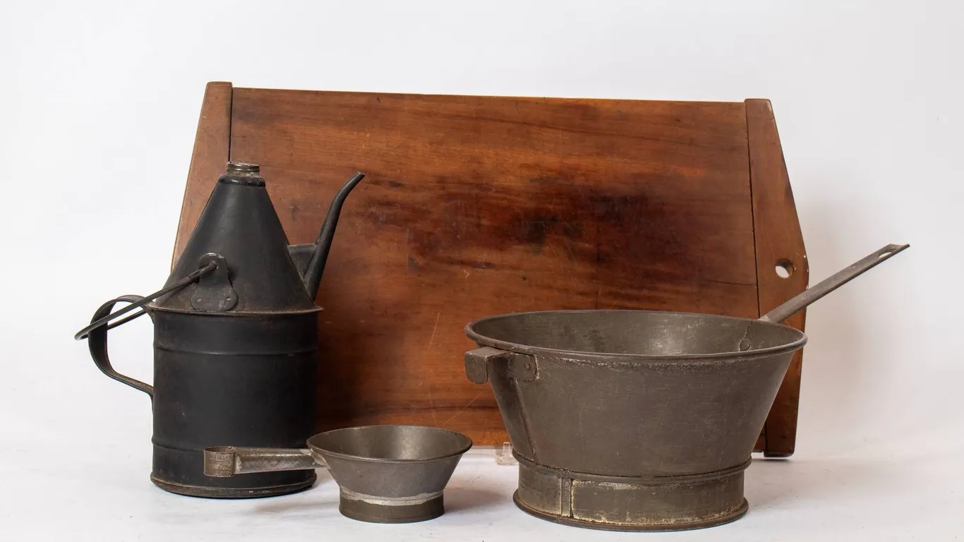 TIN LAMP FILLER, STRAINERS, AND WOODEN WORK SURFACE.