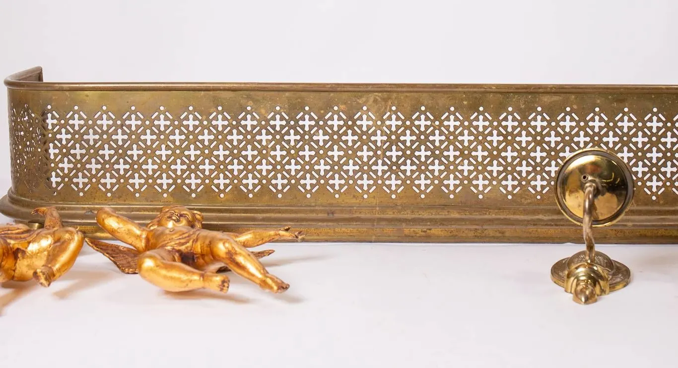 BRASS FIREPLACE FENDER AND GOLD CHERUB SCONCES.