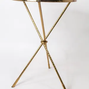 ROUND ACCENT TABLE WITH GLASS TOP AND HAMMERED BRASS FINISH.