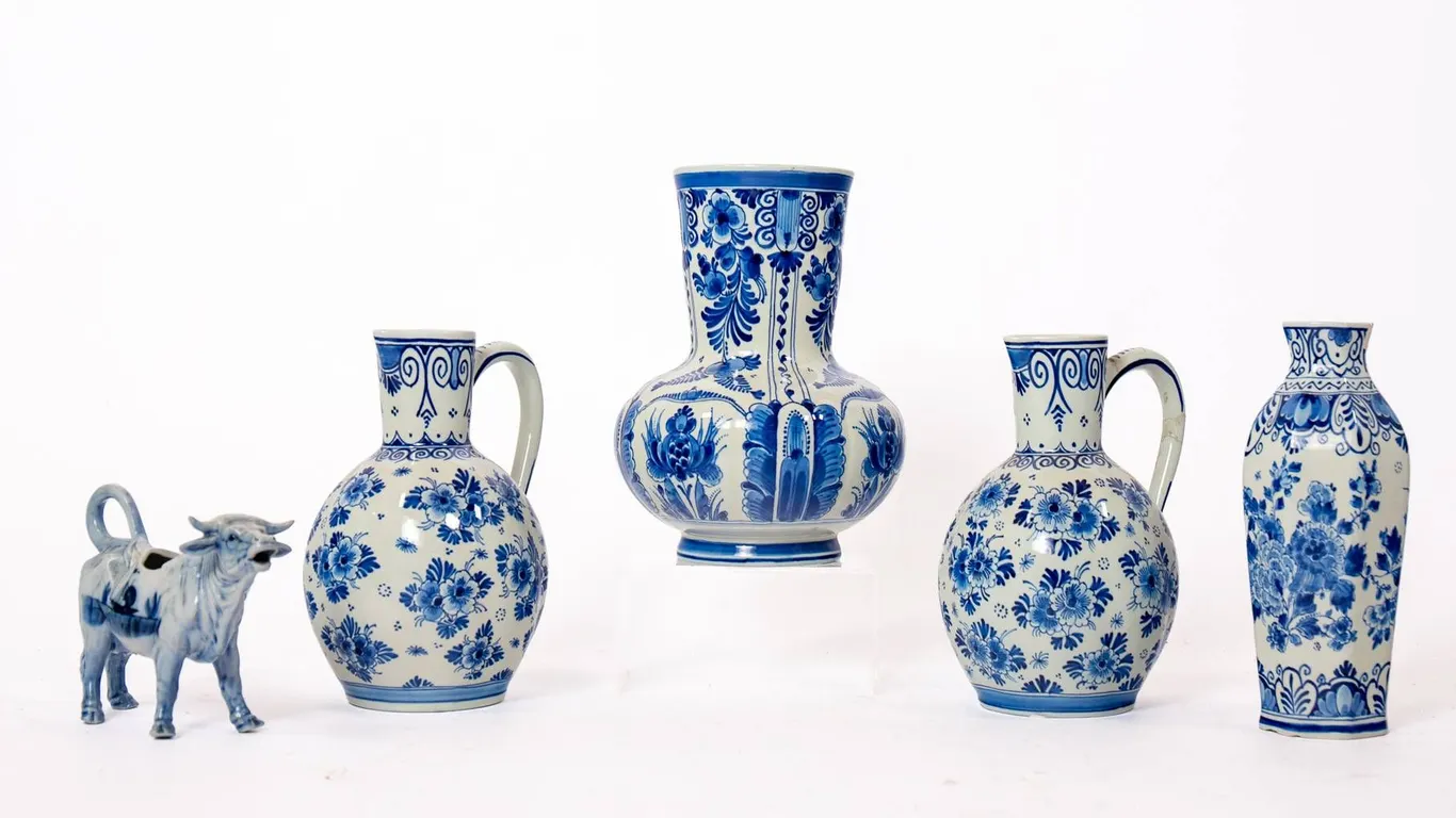 DELFT POTTERY INCLUDING CREAMER, VASES, AND PITCHERS.