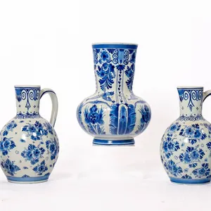 DELFT POTTERY INCLUDING CREAMER, VASES, AND PITCHERS.