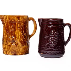 YELLOW WARE PITCHER AND BROWN GLAZED STONEWARE PITCHER.