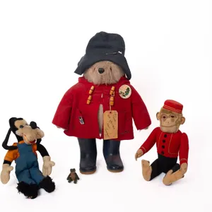 COLLECTIBLE TOYS INCLUDING PADDINGTON BEAR, GOOFY, SCHUCO MONKEY, AND FROG.