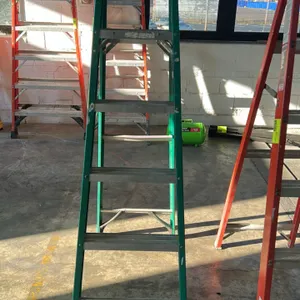 Werner 6' fiberglass stepladder. Features green fiberglass rails, aluminum steps, molded top cap, and external spreader braces. 6'H. Other ladders not