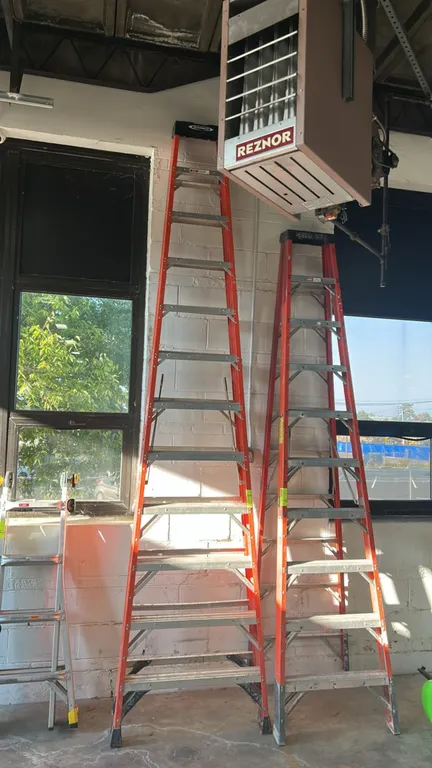 Werner 12' fiberglass stepladder. Features orange non-conductive fiberglass rails, aluminum steps, molded top cap, and spreader braces. 12'H. Other la