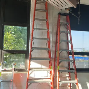 Werner 12' fiberglass stepladder. Features orange non-conductive fiberglass rails, aluminum steps, molded top cap, and spreader braces. 12'H. Other la