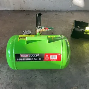OEMTOOLS 24449 5-gallon tire bead seater. Features a steel air storage tank, integrated carry handle, pressure gauge, ball discharge valve with barrel