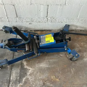 OTC 5018A hydraulic clutch handler jack. Features 300 lb max capacity and includes assorted spline shafts. Manual hydraulic pump operation. Mounted on