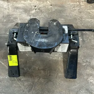 Fifth-wheel trailer hitch. Features pivoting hitch head, dual support legs with quick-release mounting pins, and side-mounted release handle with grip