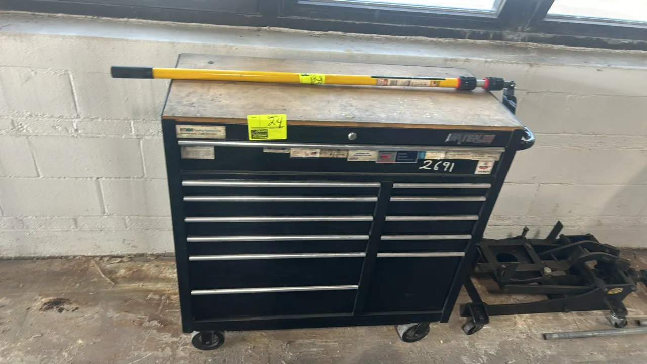 Waterloo Traxx Series multi-drawer rolling tool chest. Features black steel construction, wood work surface top, side push handle, and multi-drawer st