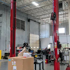 Rotary Lift SPO12N7T8 two-post automotive lift. Features 12,000 lb capacity, overhead beam configuration, symmetric arms, and a Graco retractable hose