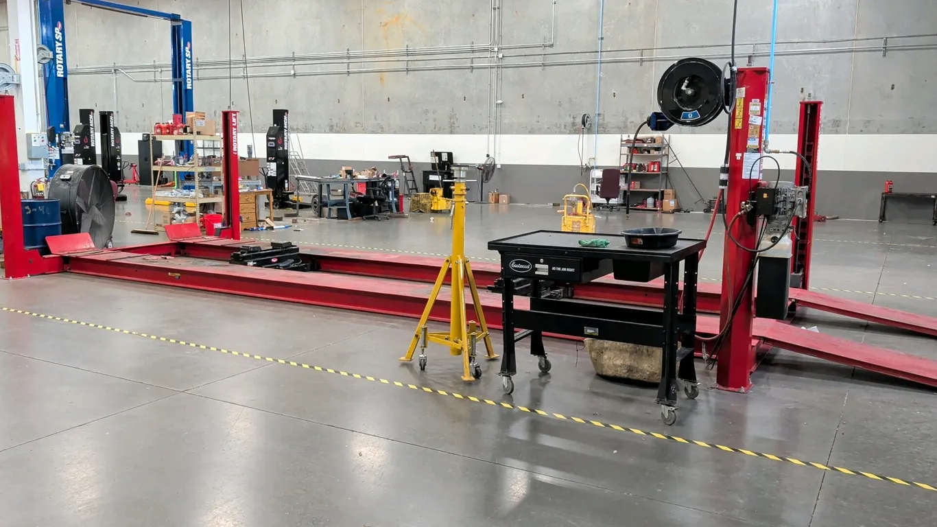 Rotary SM30N012 4-post drive-on vehicle lift. Features 30,000 lb capacity, dual runways, approach ramps, and (2) rolling bridge jacks. S/N: KIY17K0004